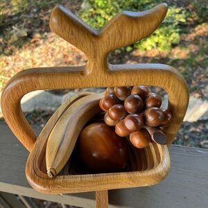 Wooden collapsible fruit basket with wooden apple, banana and grape cluster